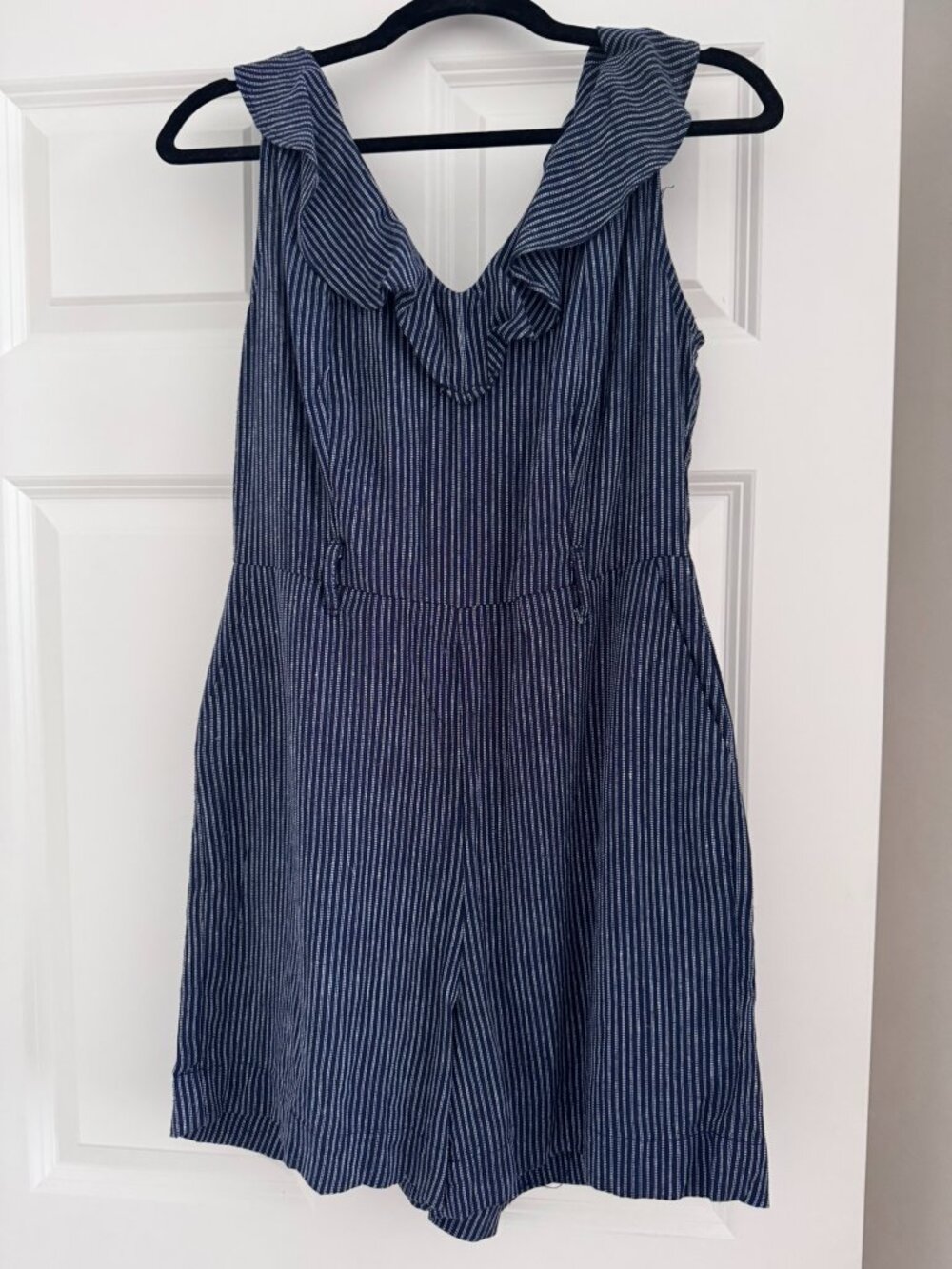 Blue and white striped sleeveless short jumpsuit with a ruffled V-neckline